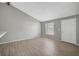 Living room with gray walls, wood-look tile floors, and vaulted ceiling at 3110 Elmer St, Sarasota, FL 34231