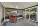 Spacious screened porch with tile floor, wicker chair, and sliding glass doors at 3110 Elmer St, Sarasota, FL 34231