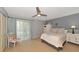 Bright bedroom with a queen-size bed and access to a balcony at 3206 Ramblewood N Dr # 18D, Sarasota, FL 34237