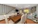 Spacious dining area with a wooden table and gray couches at 3206 Ramblewood N Dr # 18D, Sarasota, FL 34237