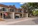 View of townhouses with parking and landscaping at 3206 Ramblewood N Dr # 18D, Sarasota, FL 34237