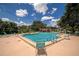 Community swimming pool with lounge chairs at 3206 Ramblewood N Dr # 18D, Sarasota, FL 34237
