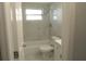 Updated bathroom with a shower/tub combo and marble-look tile at 3301 Ash St, Punta Gorda, FL 33950