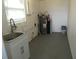 Laundry room with sink, water heater, and storage at 3301 Ash St, Punta Gorda, FL 33950