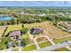Expansive aerial view of a single-Gathering home, showcasing a circular driveway, swimming pool and sizable backyard at 3310 Twin Rivers Trl, Parrish, FL 34219