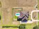A bird's eye view shows the lovely pool and deck situated in the expansive, fenced-in backyard at 3310 Twin Rivers Trl, Parrish, FL 34219