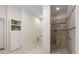 Spacious bathroom with a tiled walk-in shower, built in shelves, and linen cabinet at 3310 Twin Rivers Trl, Parrish, FL 34219