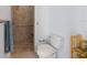 Well-lit bathroom featuring a tiled walk-in shower with a built-in seat and a modern toilet at 3310 Twin Rivers Trl, Parrish, FL 34219