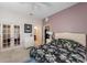 Cozy bedroom features floral bedding, light tile floors, and a doorway to the bathroom at 3310 Twin Rivers Trl, Parrish, FL 34219