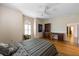 Bedroom features a ceiling fan, arched window, and built in wooden desk with drawers at 3310 Twin Rivers Trl, Parrish, FL 34219