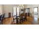 Elegant dining room featuring hardwood floors, a chandelier, and a stylish table setting at 3310 Twin Rivers Trl, Parrish, FL 34219
