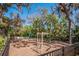 Community playground with various climbing structures and play areas, surrounded by lush trees at 3310 Twin Rivers Trl, Parrish, FL 34219