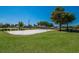 Community volleyball court with a well-maintained sand surface, set against a backdrop of green lawns at 3310 Twin Rivers Trl, Parrish, FL 34219