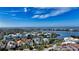 Aerial view of a luxurious home with a waterfront view, surrounded by lush greenery at 3580 Fair Oaks Ln, Longboat Key, FL 34228