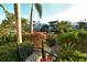 Lush backyard landscaping leads to private dock with water access and serene views at 3580 Fair Oaks Ln, Longboat Key, FL 34228
