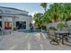 Backyard featuring a private pool, outdoor seating, lush greenery, and an inviting space for relaxation and enjoyment at 3580 Fair Oaks Ln, Longboat Key, FL 34228
