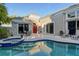 Resort-style backyard with a sparkling pool, patio seating, lush greenery, and a tranquil outdoor oasis at 3580 Fair Oaks Ln, Longboat Key, FL 34228