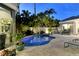 Relaxing backyard pool and patio area, perfect for outdoor entertaining, surrounded by lush tropical landscaping at 3580 Fair Oaks Ln, Longboat Key, FL 34228