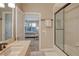 Bathroom featuring a tiled shower with glass door and a view to the bedroom with blue/white accents at 3580 Fair Oaks Ln, Longboat Key, FL 34228