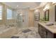 Luxurious bathroom with a soaking tub, glass shower, and double sink vanity with dark cabinets at 3580 Fair Oaks Ln, Longboat Key, FL 34228
