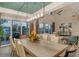 Elegant dining room features water views, modern lighting, and flows to living area at 3580 Fair Oaks Ln, Longboat Key, FL 34228