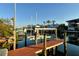 Private dock on calm waters with boat lift provides convenient waterfront access at 3580 Fair Oaks Ln, Longboat Key, FL 34228