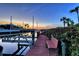 Picturesque dock view at sunset with peaceful atmosphere and seating area at 3580 Fair Oaks Ln, Longboat Key, FL 34228