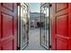 Grand entrance with elegant iron gates, leading to a beautiful courtyard, and a glimpse of the home's architecture at 3580 Fair Oaks Ln, Longboat Key, FL 34228
