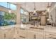 Bright kitchen features a large island, stainless steel appliances, and backyard pool view at 3580 Fair Oaks Ln, Longboat Key, FL 34228