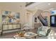 Bright living room featuring stylish decor, comfortable seating, and a staircase, creating an inviting and elegant space at 3580 Fair Oaks Ln, Longboat Key, FL 34228