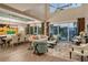 Open-concept living and dining area with hardwood floors, high ceilings, modern furnishings, and ample natural light at 3580 Fair Oaks Ln, Longboat Key, FL 34228