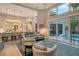 Open-concept living room with high ceilings, a fireplace, and access to the backyard at 3580 Fair Oaks Ln, Longboat Key, FL 34228