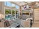 Bright living room offering backyard pool views and a built-in media center at 3580 Fair Oaks Ln, Longboat Key, FL 34228