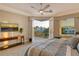 Bright main bedroom with balcony access, ceiling fan, and mounted television at 3580 Fair Oaks Ln, Longboat Key, FL 34228