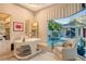 Bright office space with a view of the pool and backyard, includes a desk and comfortable seating at 3580 Fair Oaks Ln, Longboat Key, FL 34228