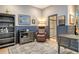Office space includes a desk, bookcase, comfortable armchair and art, leading to an ensuite bathroom at 3580 Fair Oaks Ln, Longboat Key, FL 34228