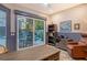 Comfortable home office leading to the outdoor pool and patio area, with a desk, leather chair, and bookshelf at 3580 Fair Oaks Ln, Longboat Key, FL 34228