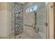 Modern bathroom featuring a glass enclosed shower with marble-style tiling and stone hexagon shower accent wall at 3580 Fair Oaks Ln, Longboat Key, FL 34228