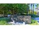 Entrance sign for Bay Isles Beach Club, a private community nestled amidst lush greenery at 3580 Fair Oaks Ln, Longboat Key, FL 34228