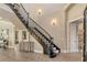 Elegant foyer with dark wood staircase and hardwood floors, featuring stylish decor at 3580 Fair Oaks Ln, Longboat Key, FL 34228
