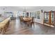 Bright dining room with a large wooden table, hardwood floors, and kitchen views at 3611 99Th W St, Bradenton, FL 34210