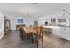 Elegant dining room featuring a long table and hardwood floors, open to the kitchen at 3611 99Th W St, Bradenton, FL 34210