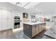 Modern kitchen with white cabinets, stainless steel appliances, and large island at 3611 99Th W St, Bradenton, FL 34210