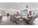 Open concept living space with sectional sofa, hardwood floors, and access to other rooms at 3611 99Th W St, Bradenton, FL 34210