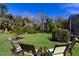 Spacious backyard with lush landscaping and seating area at 3649 Wilderness W Blvd, Parrish, FL 34219