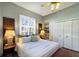 Comfortable guest bedroom with a queen-size bed and built-in shelving at 3649 Wilderness W Blvd, Parrish, FL 34219