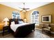 Primary bedroom with king-size bed and sitting area at 3649 Wilderness W Blvd, Parrish, FL 34219