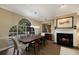 Bright dining room with hardwood floors, a fireplace, and large windows at 3649 Wilderness W Blvd, Parrish, FL 34219