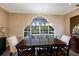 Elegant dining room with hardwood floors, a large arched window, and pool view at 3649 Wilderness W Blvd, Parrish, FL 34219