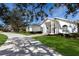 House exterior showcasing a long driveway and manicured lawn at 3649 Wilderness W Blvd, Parrish, FL 34219